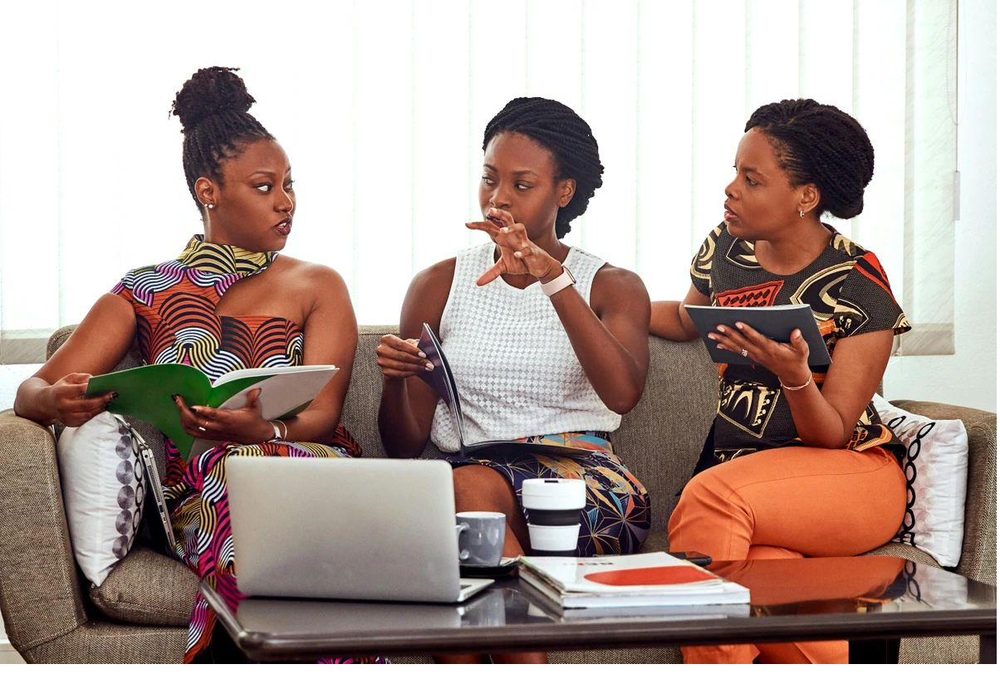 Three learners talking through a project together
